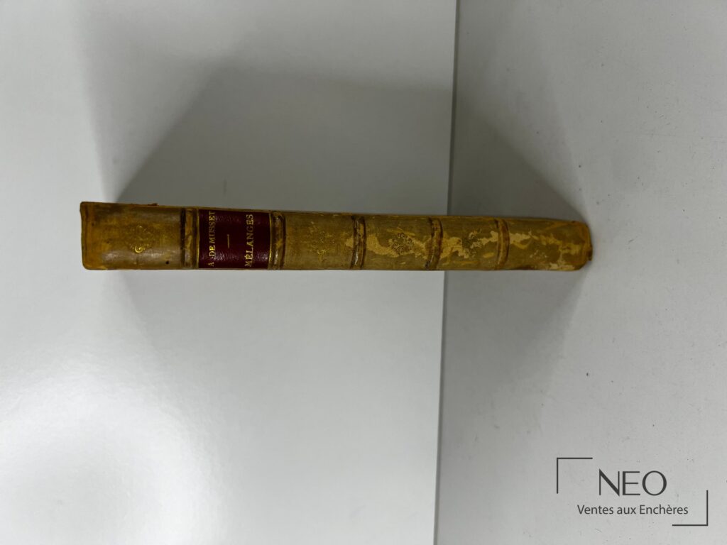 Dos en demi basane à nerfs avec pièce de titre rouge portant le nom de Musset