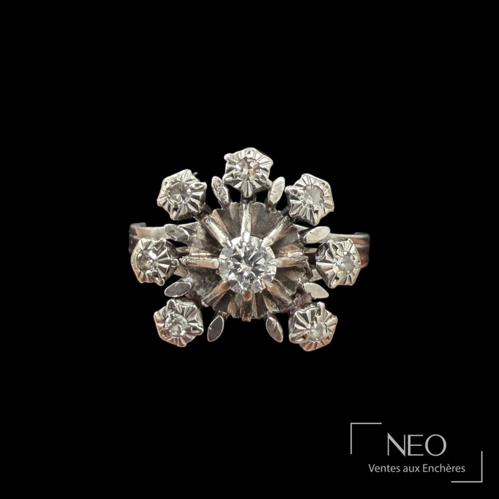 Bague marguerite en or gris sertie d'un diamant central entouré de diamants