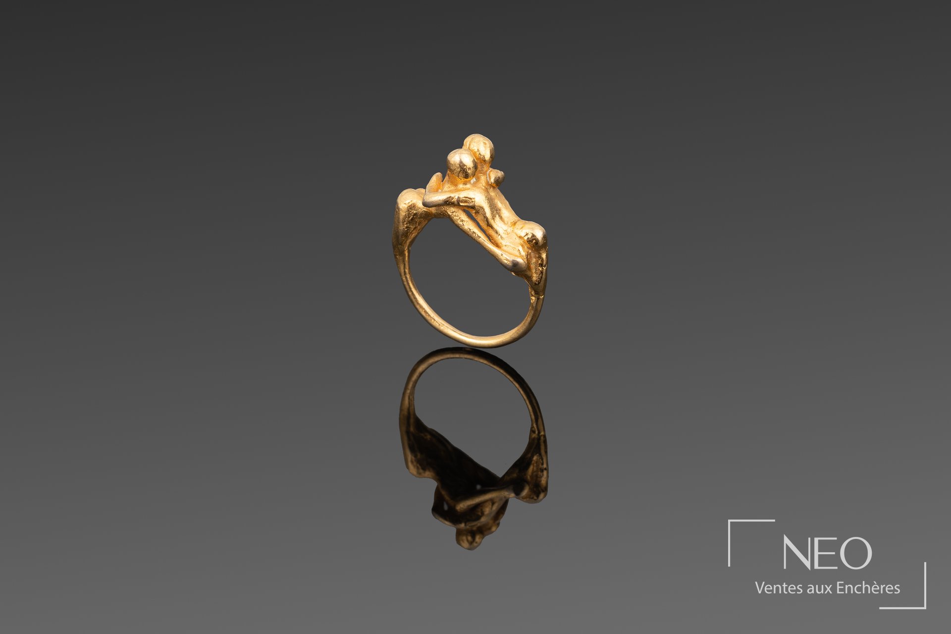 Bague en métal doré figurant deux amants enlacés