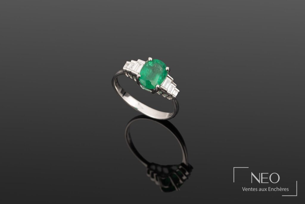 Bague en or blanc sertie d'une émeraude ovale et de diamants baguette