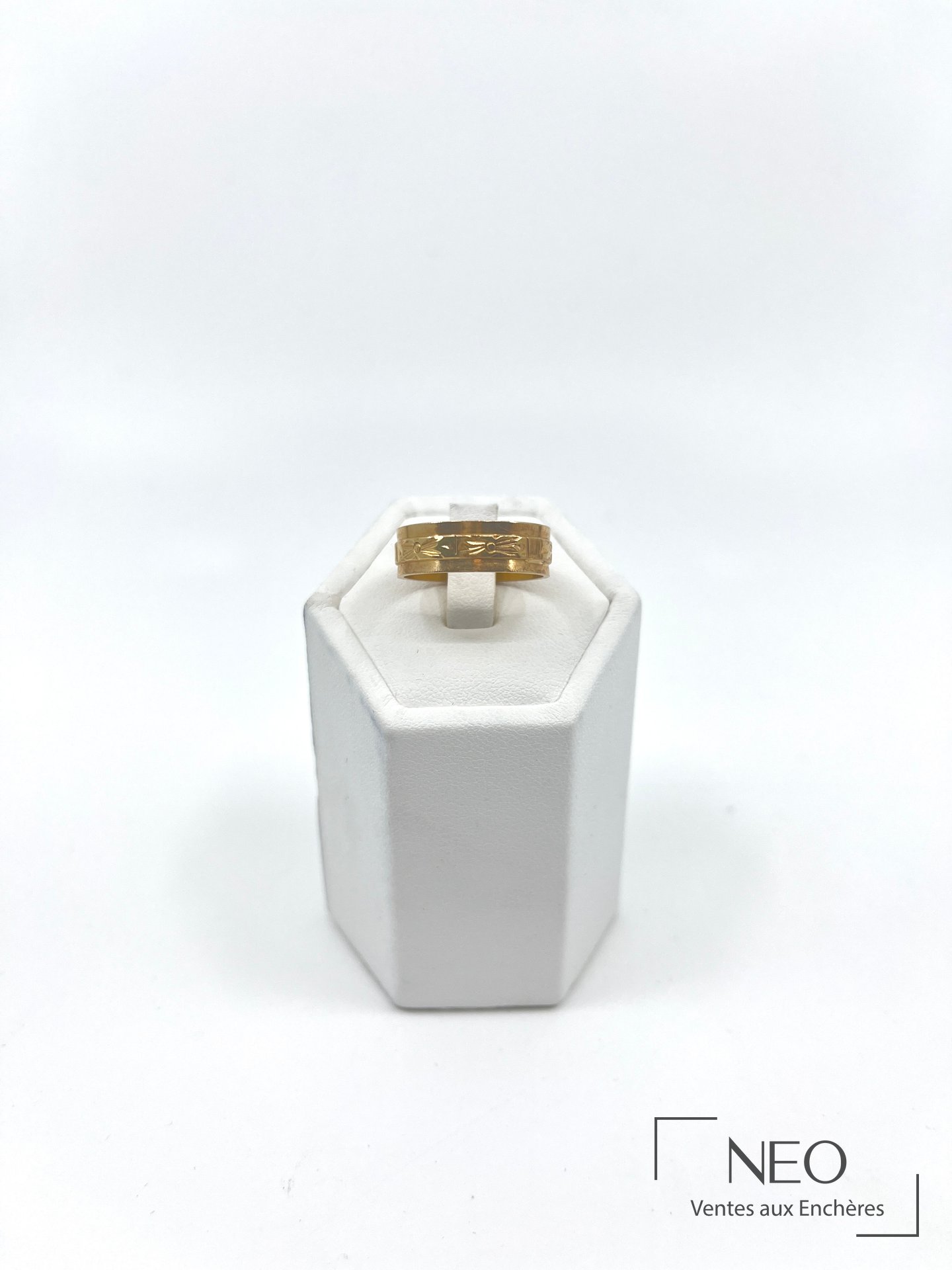 Bague en or jaune sur support blanc
