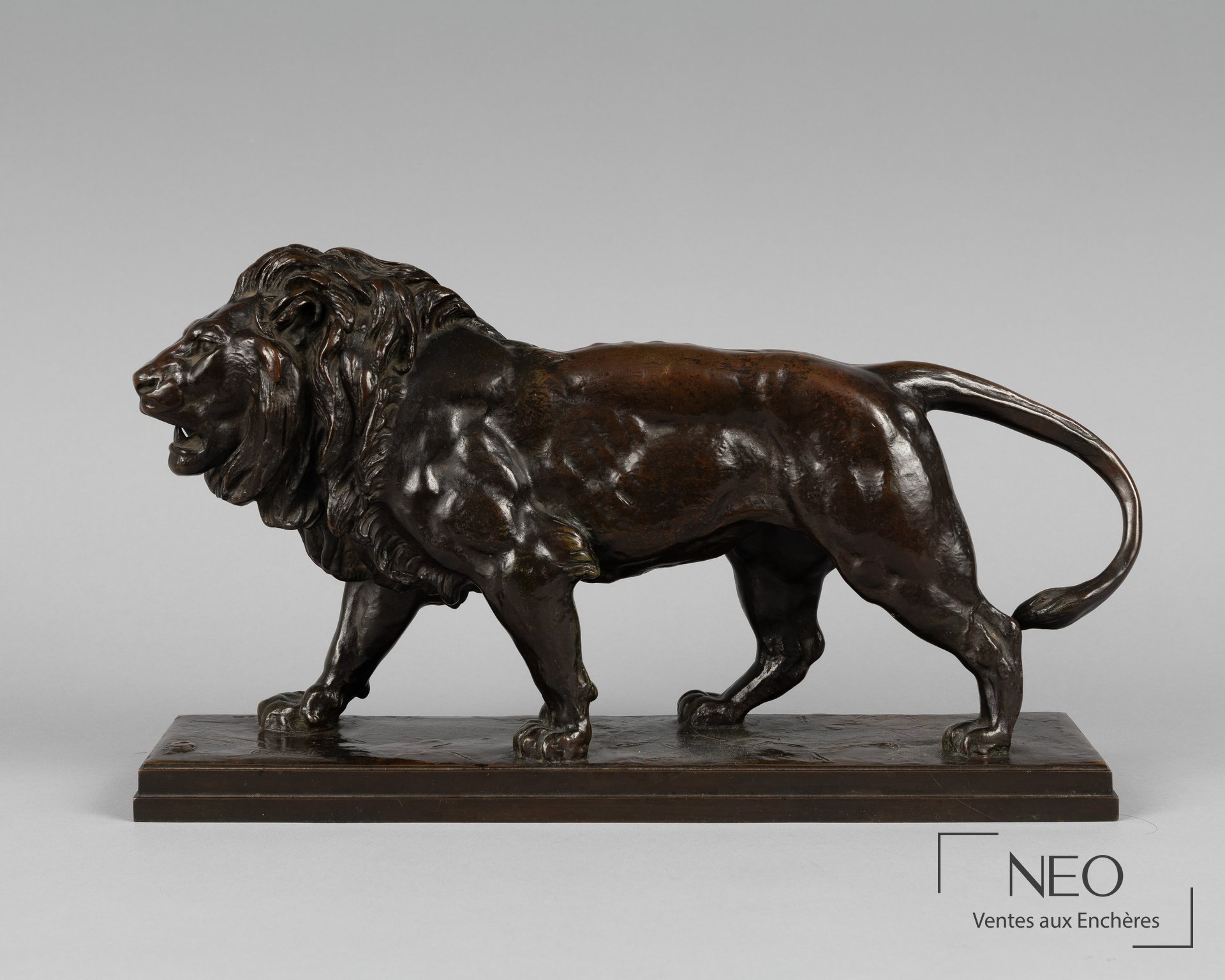 Lion en bronze marchant sur une plinthe rectangulaire