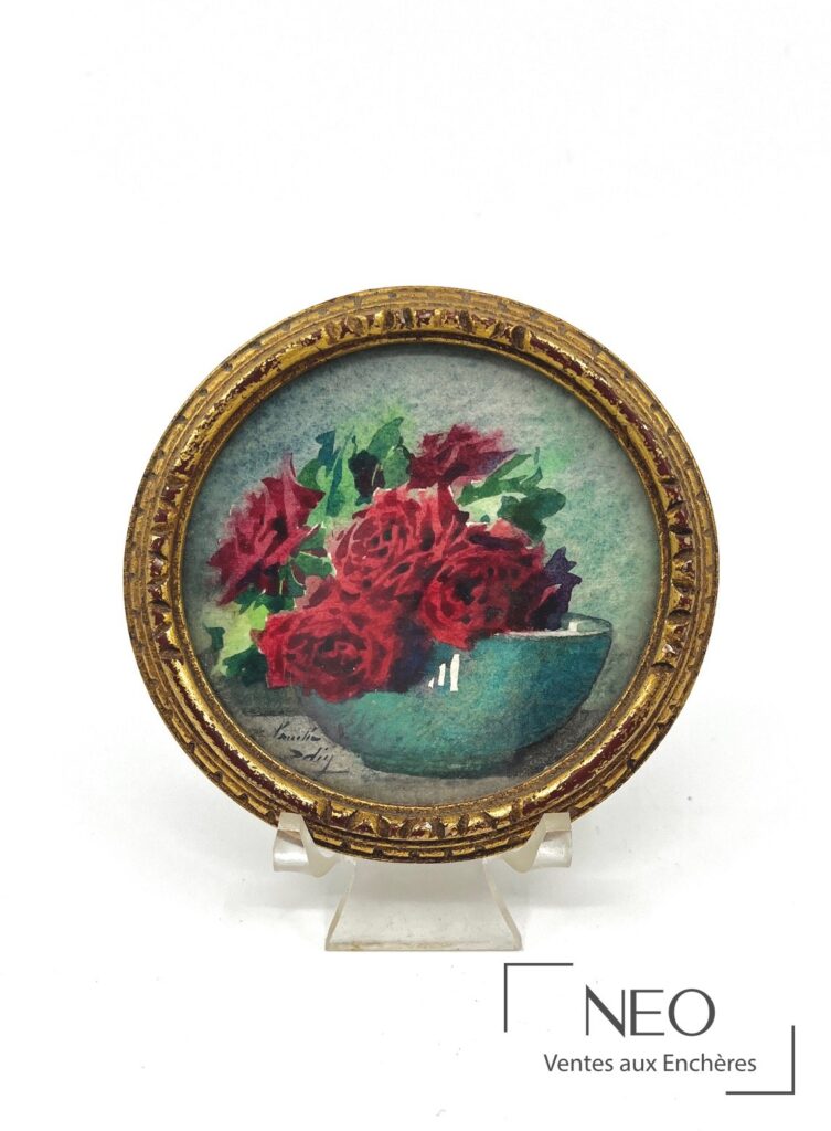 Bouquet de roses rouges dans un cadre rond doré