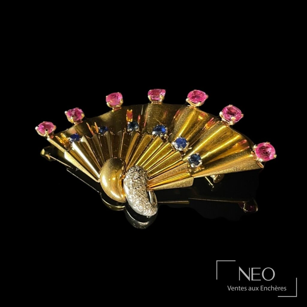 Broche éventail en or jaune sertie de saphirs roses et bleus avec motif central en diamants