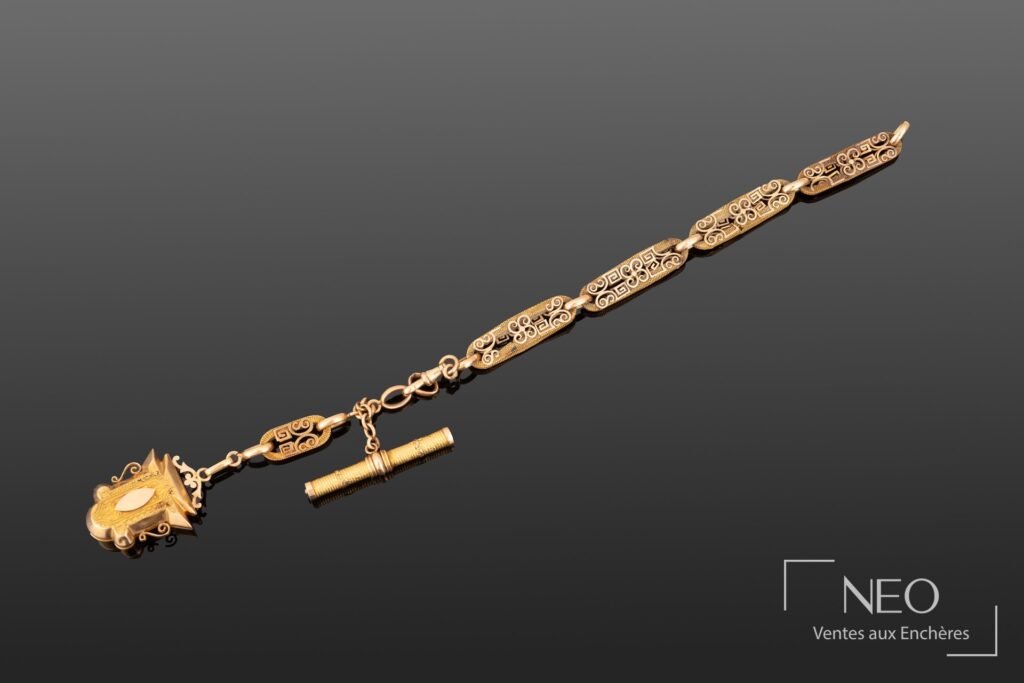 Chaîne de montre en or jaune et or rose avec pendentif porte-photo et élément cylindrique