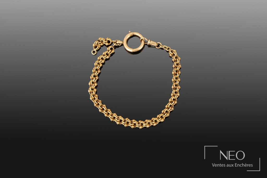 Chaîne de montre en or à maille forçat double imbriquée