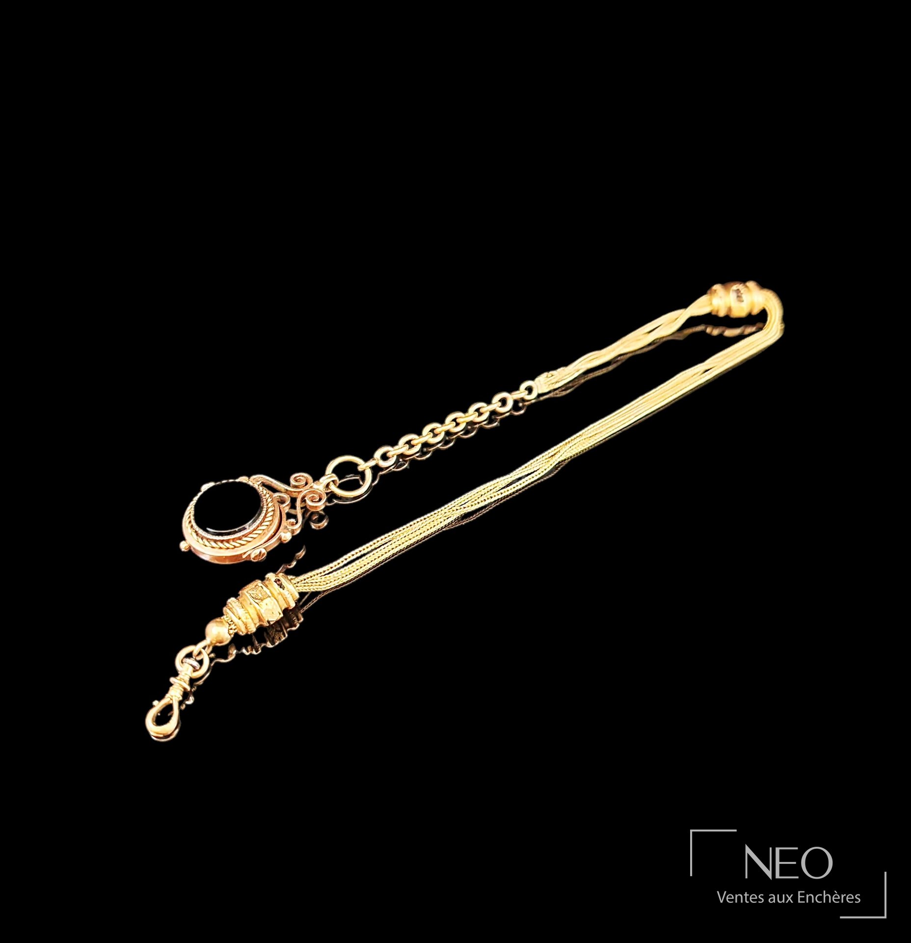 Chaîne giletière en ors rose et jaune 18 carats, pendentif à onyx noir rotatif