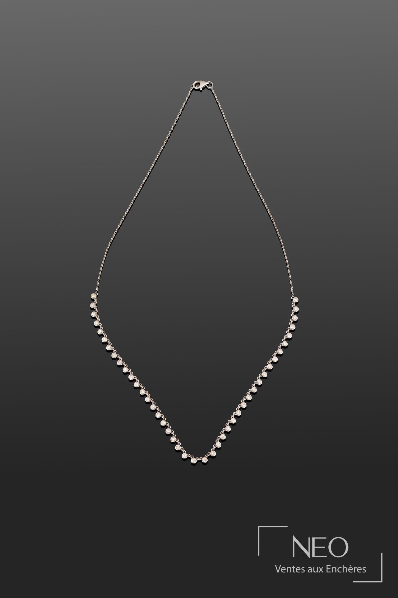 Collier ligne en or blanc avec rangée de diamants taille brillant sur fond gris