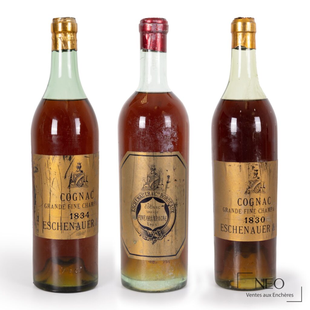 Trois bouteilles de cognac Eschenauer Grande Fine Champagne avec étiquettes et capsules usées