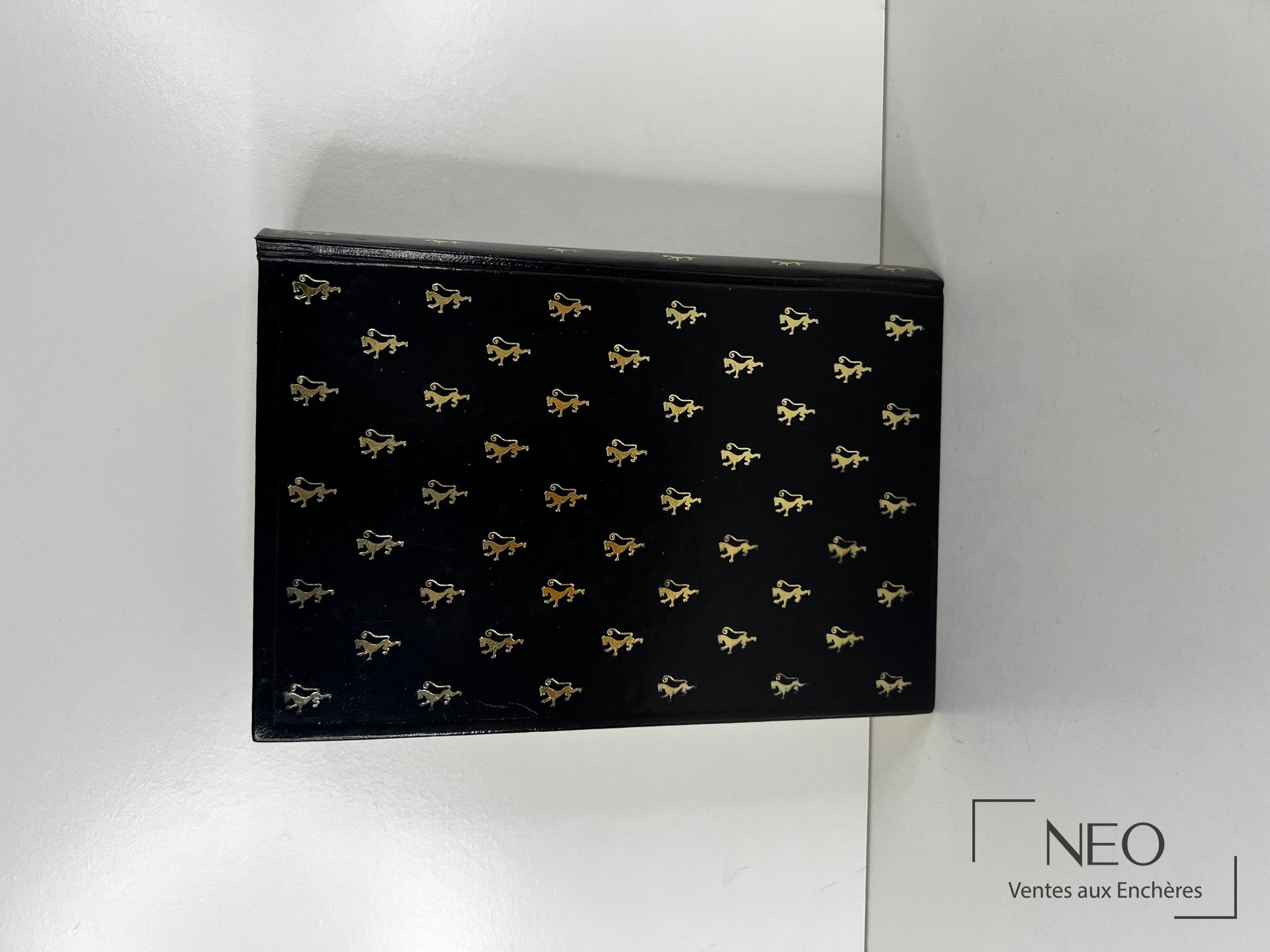 Couverture noire ornée de petits motifs dorés répétés