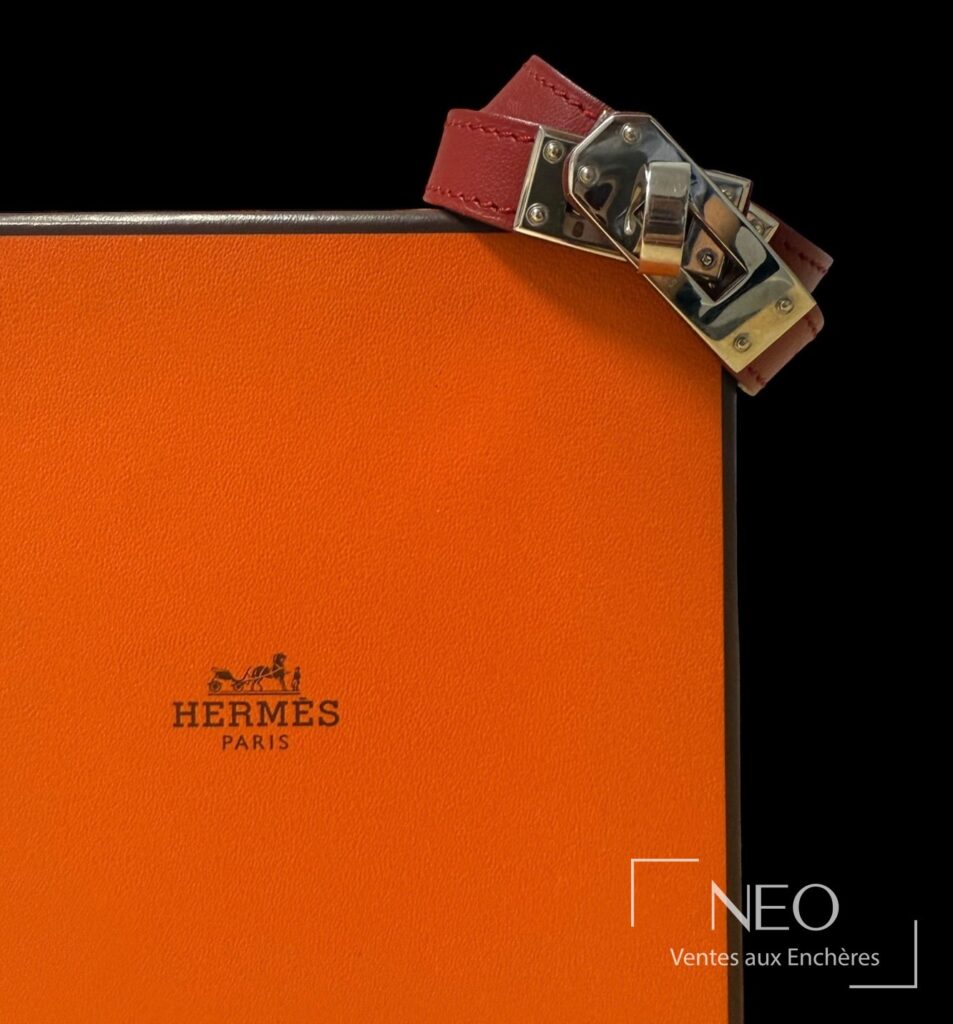 Bracelet Hermès double tour rouge posé sur son écrin orange