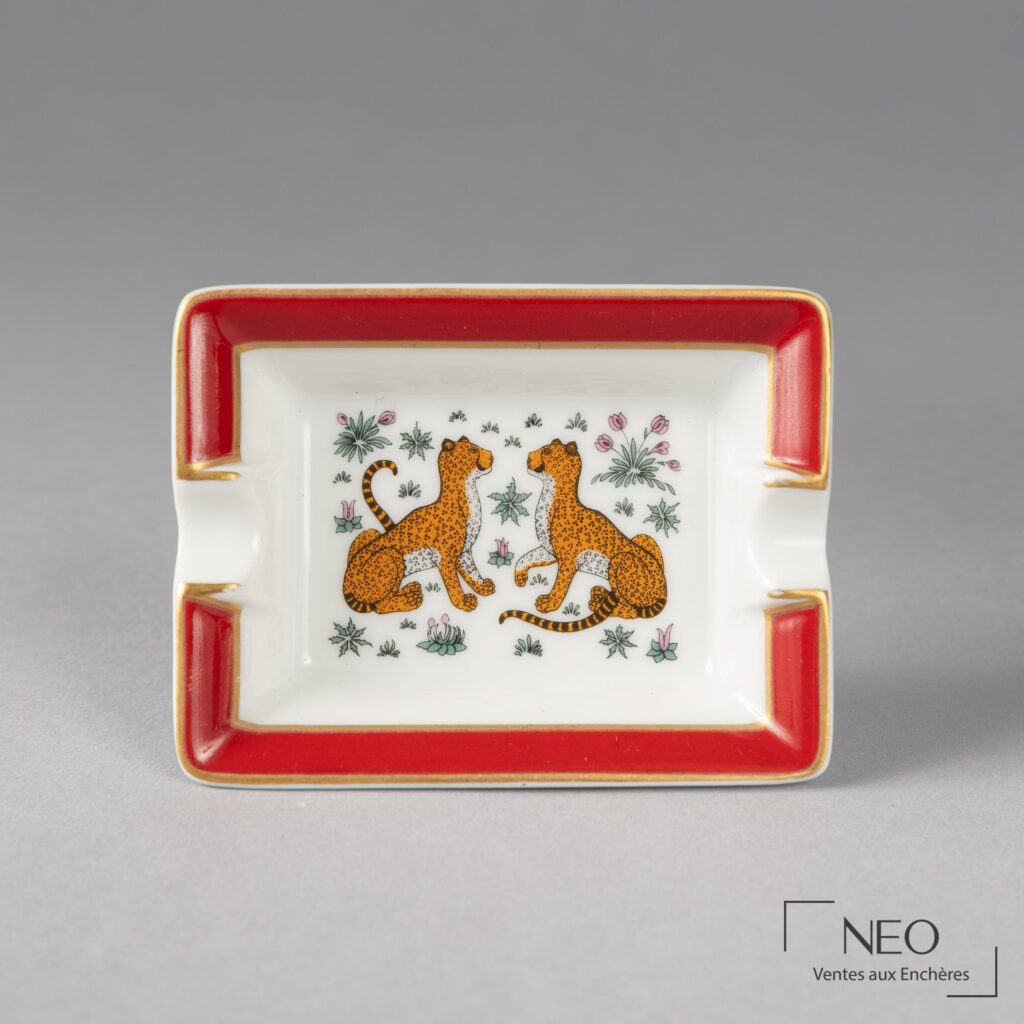 Petit cendrier Hermès en porcelaine blanche à décor de deux panthères et bord rouge