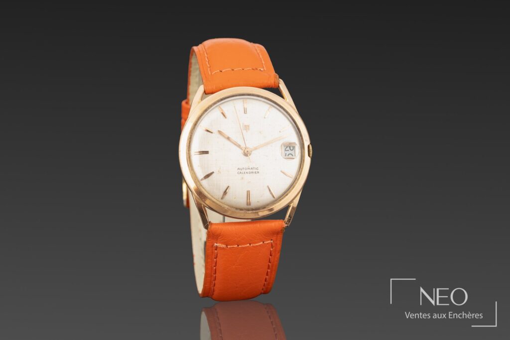 Montre LIP Calendrier en or jaune avec cadran argenté et bracelet orange