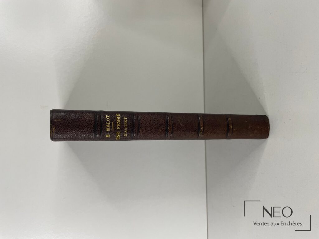 Dos en demi chagrin brun avec nerfs et titre doré de Une femme d'argent