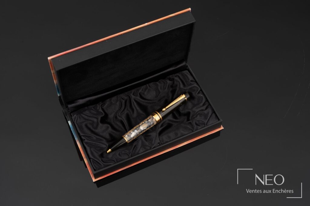 Stylo bille Montblanc Alexandre Dumas présenté dans son coffret ouvert sur fond noir.