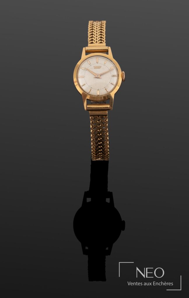 Montre bracelet Tissot en or jaune à cadran champagne et index bâtons