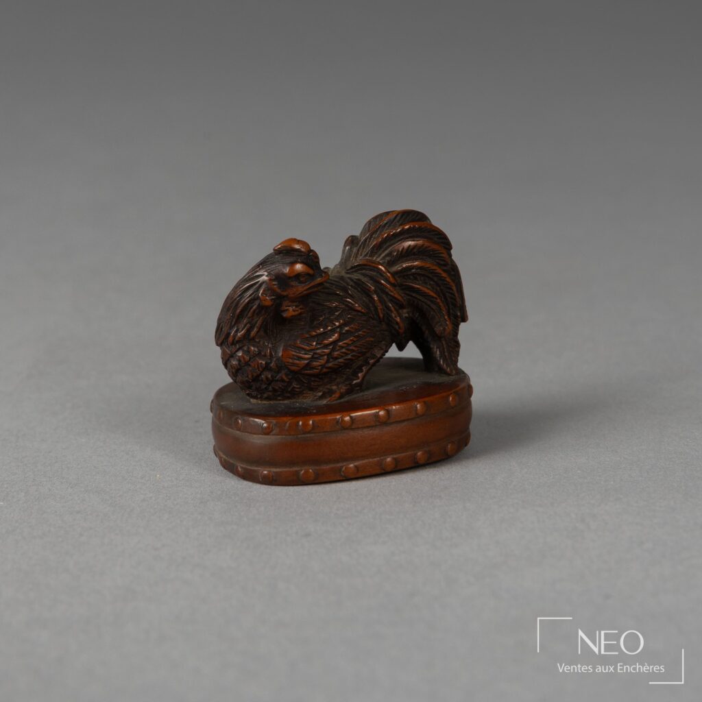 Netsuke en buis figurant un coq posé sur un tambour