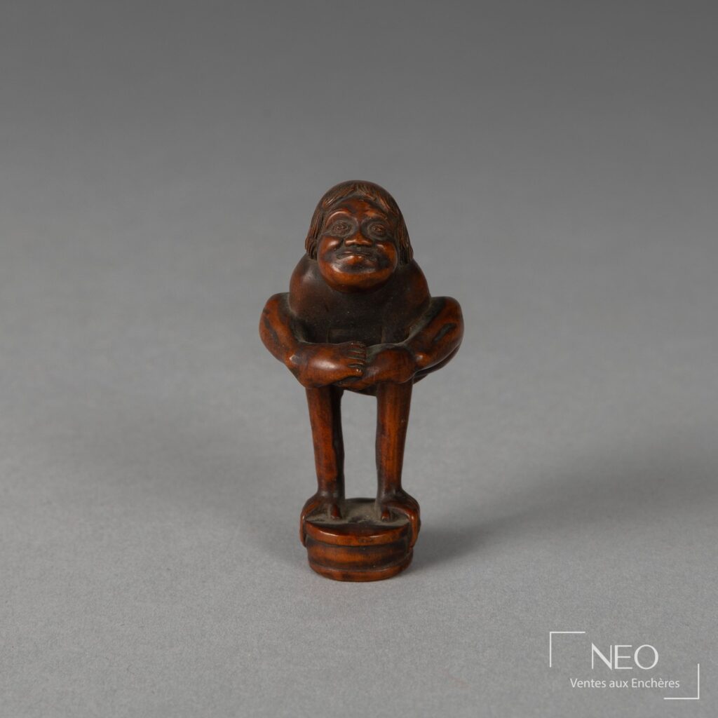 Netsuke en buis représentant un acrobate debout sur ses mains