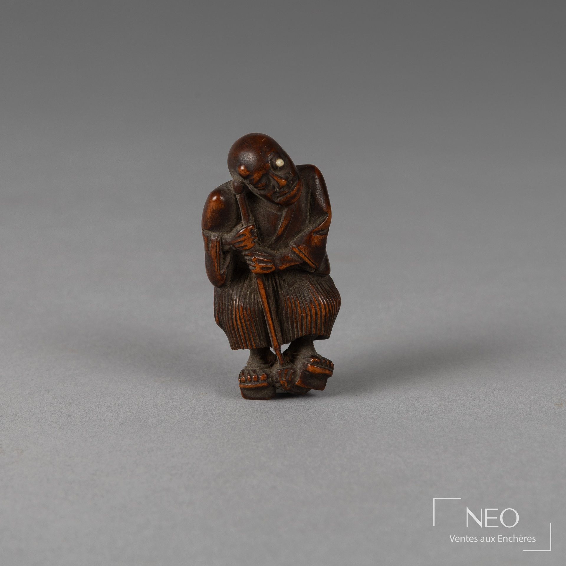 Netsuke japonais en buis représentant un aveugle debout appuyé sur son bâton