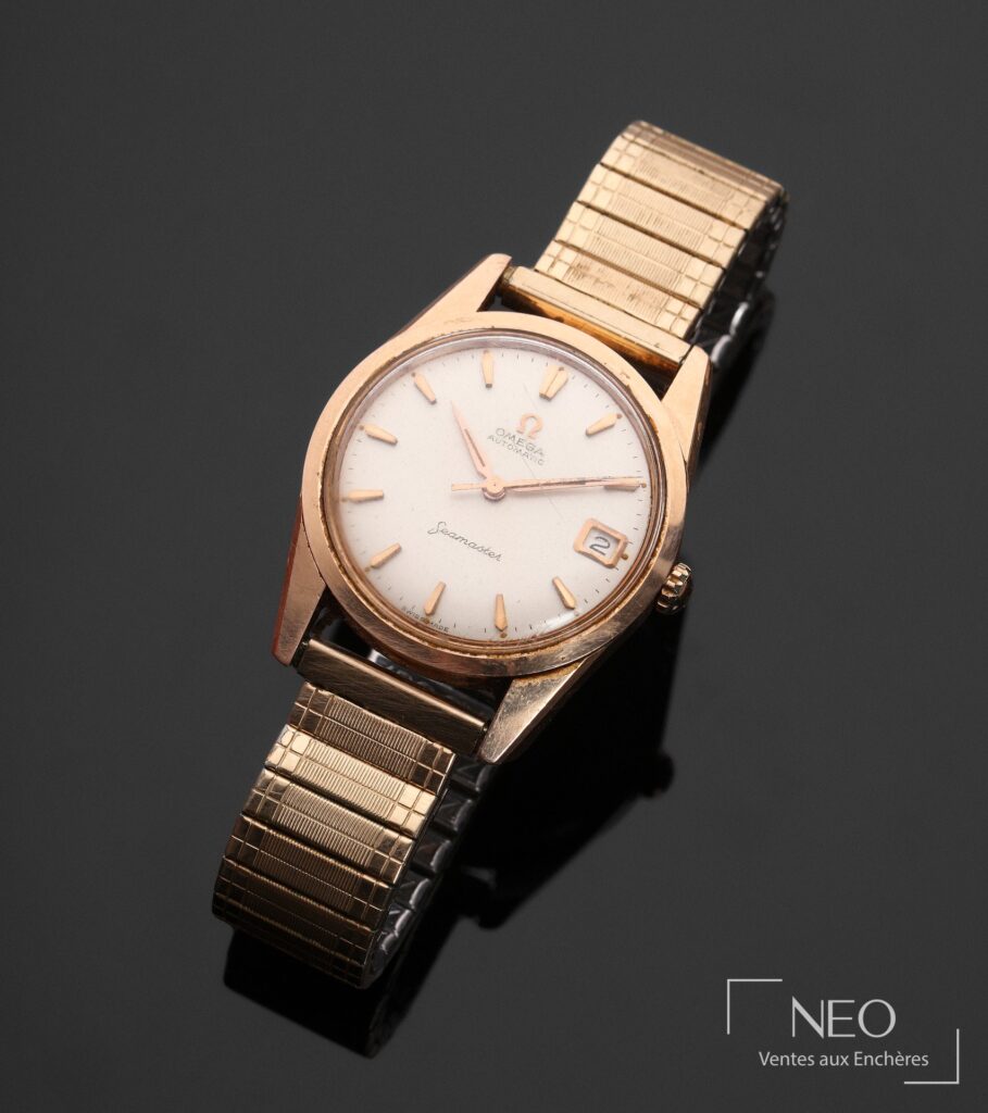 Montre Omega Seamaster en plaqué or avec cadran argenté et bracelet doré