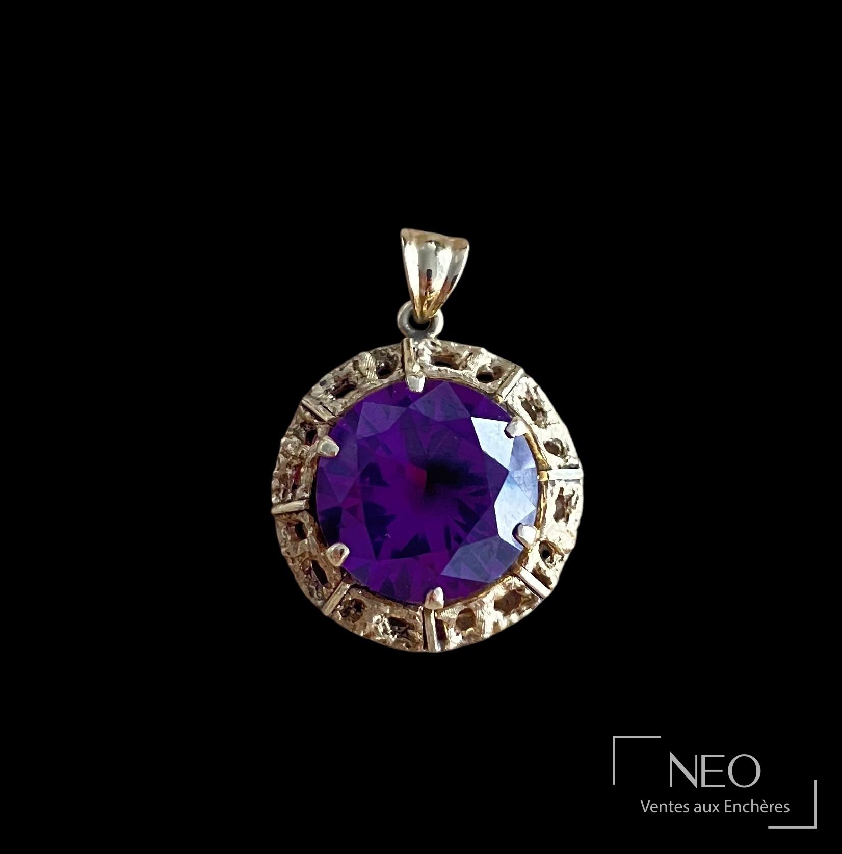 Pendentif rond en or jaune ajouré serti d'une améthyste facettée violette