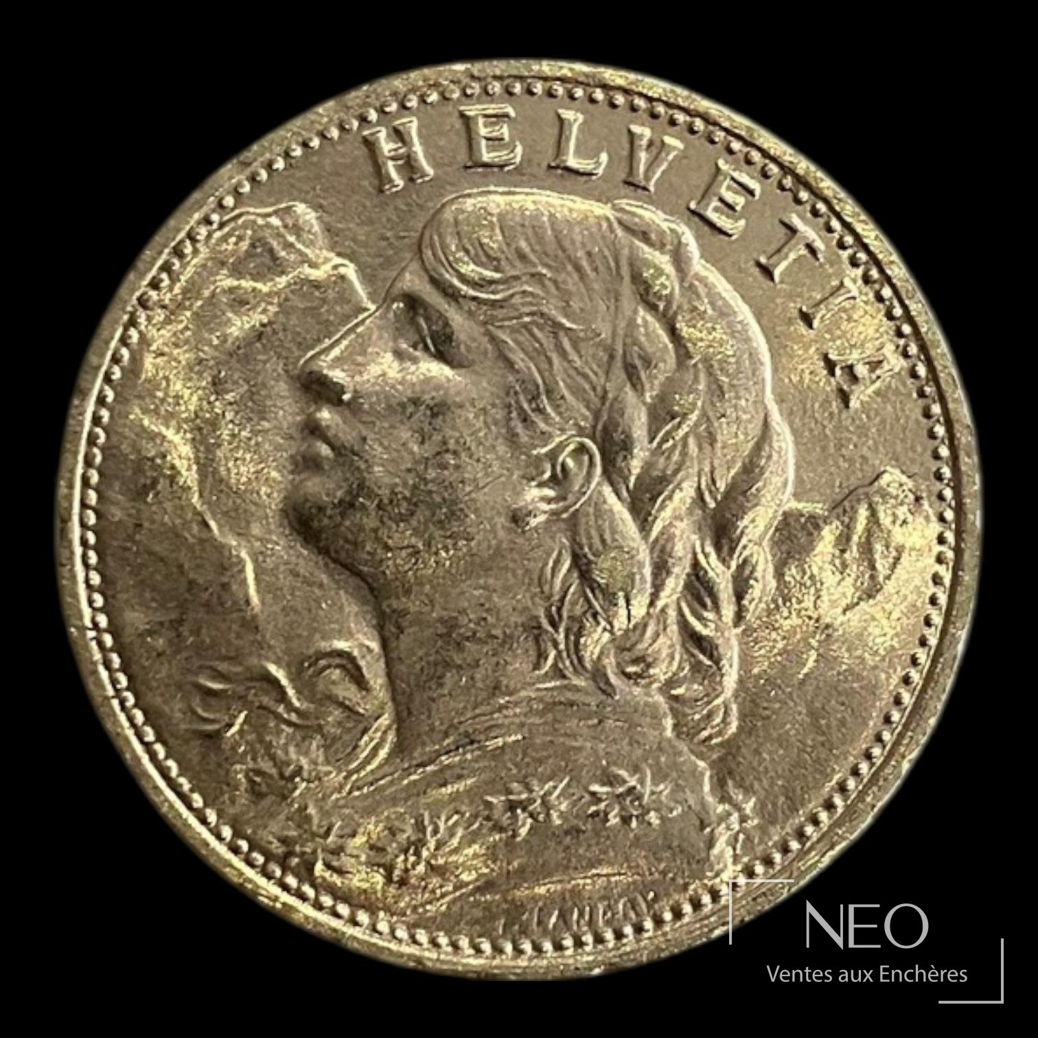 Avers d'une pièce suisse de 20 francs or avec le buste féminin et l'inscription HELVETIA.