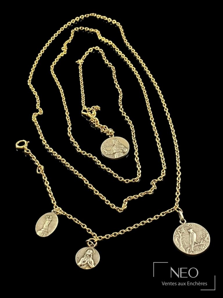 Sautoir en or jaune avec quatre médailles religieuses sur fond noir