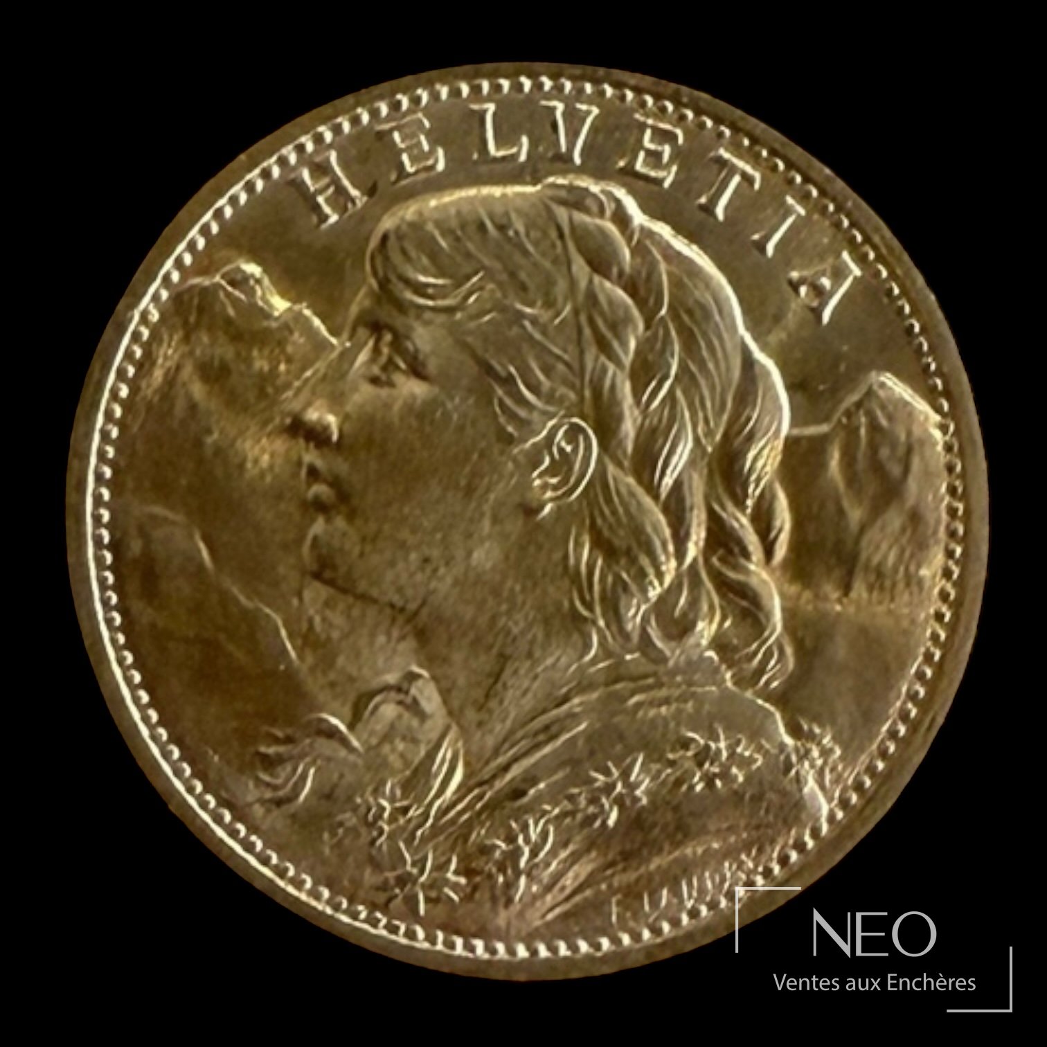Avers d'une pièce suisse Helvetia en or avec profil de femme et la mention HELVETIA.